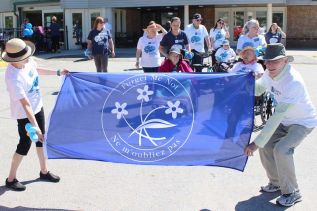Terry and Lynne Taylor were the flag bearers in the 1st annual Pine Meadows Alzheimer Walk.