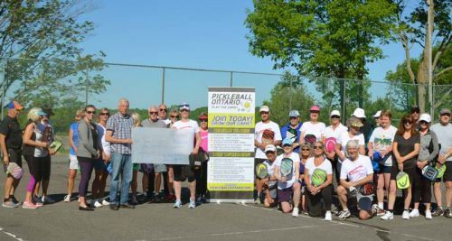 South F\\rontenac Mayor Ron VAndewal accepting a cheque for $1,000 from the Frontenac and Kingston Pickleball Associations