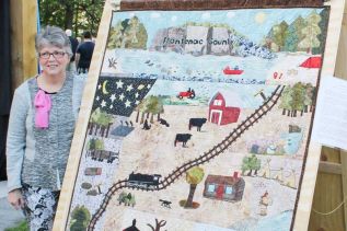Debbie Emery with her commemorative quilt