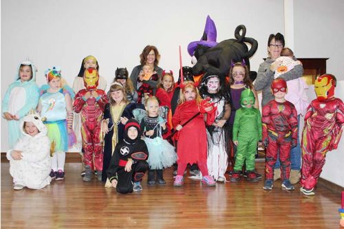 At the end of the popular costume parade, it took some doing but we finally got most of the partygoers on stage for a picture. Photo/Craig Bakay