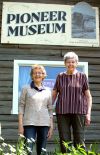 Former curator Margaret Axford and president Shirley Sedore in front of the museum at the season opening Saturday in Cloyne