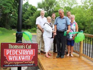 Central Frontenac Mayor Frances Smith and MPP Randy Hillier cut the ribbon on the Thomson’s Cut portion of the K & P Trail through Sharbot Lake Tuesday morning. The Cut work was financed by a $50,000 Trillium grant. Also pictured (from left) are Central Frontenac Coun. Bill MacDonald, Treasurer Michael McGovern, project chair Gary Giller and Clerk/Administrator Cathy MacMunn. Photo/Craig Bakay