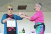 Shelley Brooks took home the top prize at the Sharbot Lake Farmers Market Butter Tart Challenge Saturday. Presenting the award was emcee Andrea Duggan. Photo/ Craig Bakay