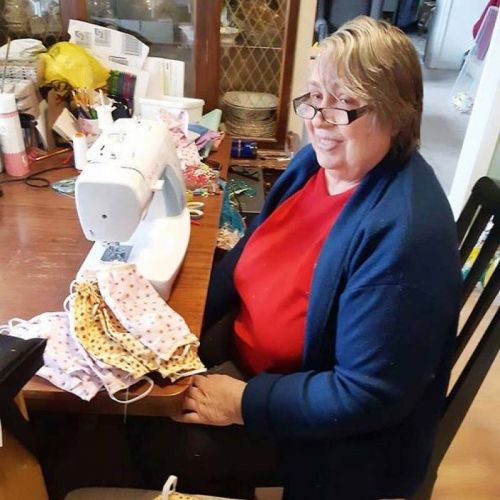 The Perth Crafters began making masks in late March, as did Rose Macpherson of Sharbot Lake. Above, Cherly Bird of Perth Road at her sewing machine