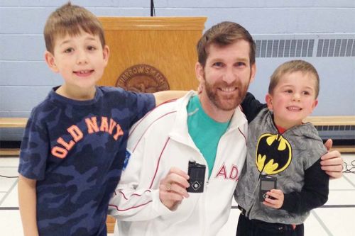 L to R: Quinn, Kieran’s older brother, Chris Jarvis, Kieran Palmer. Chris and Kieran are holding the insulin pumps they wear all the time.