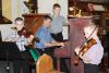 Dad Jeffrey Moellman accompanies sons Paul and Gabriel with son Jonathan turning the pages at St. Paul’s Anglican Church in Sydenham Sunday. Photo/Craig Bakay