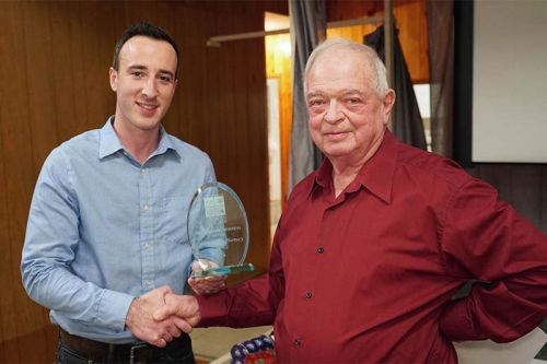 Higgins presenting the award to Eric Tobia