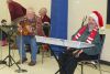 Bob Miller’s interpretation of folkish Christmas carols was a hit with crowd, including keyboardist David Yerxa, at the Ecumenical Carol Service Sunday at St. James Major Hall in Sharbot Lake. Photo/Craig Bakay