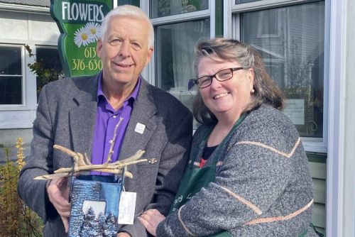 Warden Ron Vandewal presents Christine Kennedy of Memory Lane Flowers with the award, which ws created by Water's Edge Pottery.