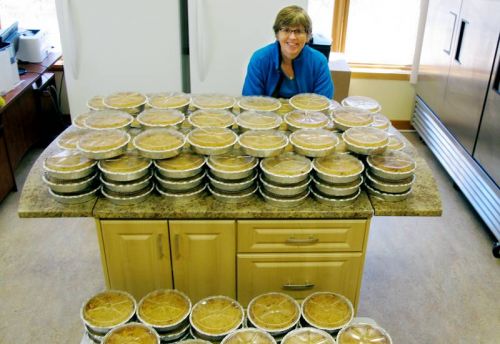 Anne Howes, former owner of the Rising Bun bakeshop, who now works fior Rural Frontenac Community Services, baked 200 apple crumbles for four last week,, with help from a crew of peelers for the community Easter Dinner