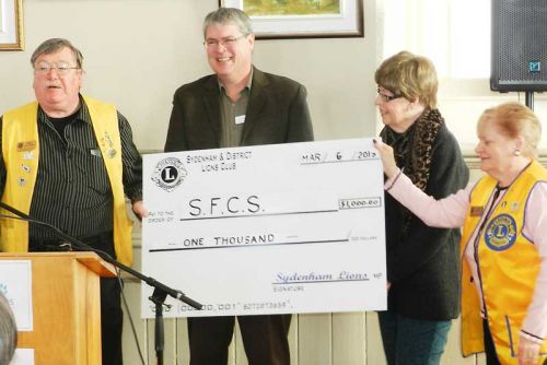 David Townsend receives a cheque for $1000 fron the Sydenham & Disttrict Lions
