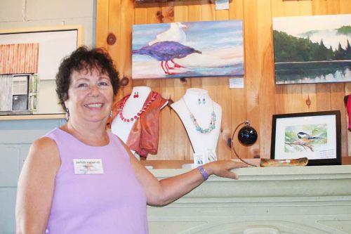Judith Versavel poses with some of her artworks in between welcoming visitors to her gallery on the bay. Photo/Craig Bakay