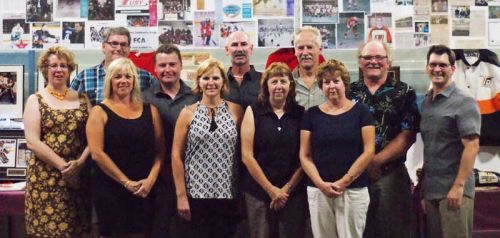 Longtime friends of the arena, in front of a wall of memories