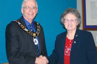 Bedford Coun. Pat Barr is congratulated by Mayor Ron Vandewal after being sworn in as Deputy Mayor for South Frontenac Council’s final year of this mandate at Tuesday night’s Council meeting. Photo/Craig Bakay