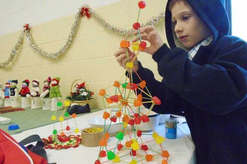 Spencer builds a tower using jujubes at the Christmas dinner