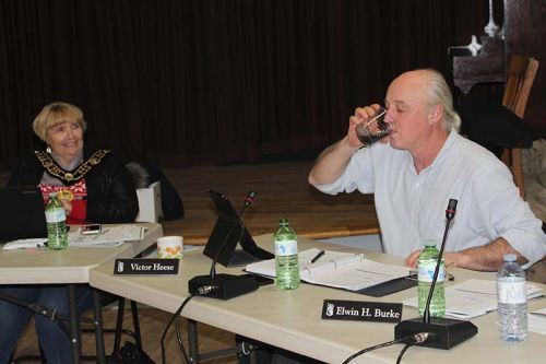 Dep. Mayor Victor Heese tries a swig of ‘gunpowder water’ (water with gunpowder in it) during a presentation from the Heritage Festival while Mayor Frances Smith looks on apprehensively at Tuesday’s Council meeting. Her Worship along with Coun. Brent Cameron also took a drink. “It tastes like salty water,” Heese said. Photo/Craig Bakay