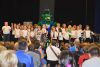 GREC&#039;s gryphon mascot joins the school’s primary/junior choir for a rousing school cheer that ended the new school official dedication ceremony on May 22