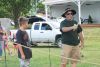 Mike Procter shows his skills to a fascinated young man at the Sharbot Lake Farmers Market