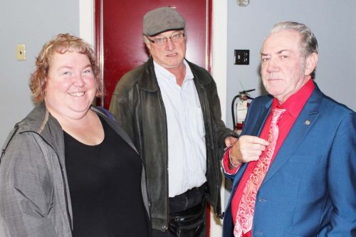 Re-elected Coun. Victor Heese coaches new Central Frontenac Council members Nicki Gowdy and Elwin Burke on posing for pictures on election night. Photo/Craig Bakay