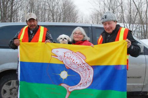  KI band members unfurl their flag in Sharbot Lake and Kaladar