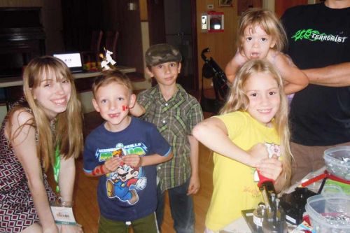 Librarian Liz Coates with avid button makers young and old at the KFPL's Mini Maker Faire at Oso Hall on July 3