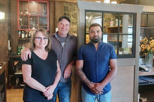 Sandra & Frank White hand the keys to the Sharbot Lake Country Inn over to Gobi Nada.