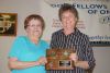 L-r: Barb Garrison is presented with a plaque by Brenda Taylor and recognized for her 41 years as Keeper of the Key at the Golden Links Hall in Harrowsmith