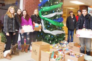 tudents in GREC's Lakers program with some of the 1000 food items collected and donated to the local food bank