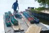 Milk crates full of river rock ready to be barged to the shoal for placement